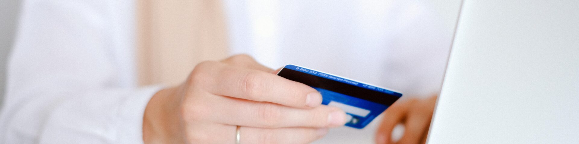Online betalen, foto van een bankpas naast een computer, afbeelding bij Werkgever betaalt pensioenadvies