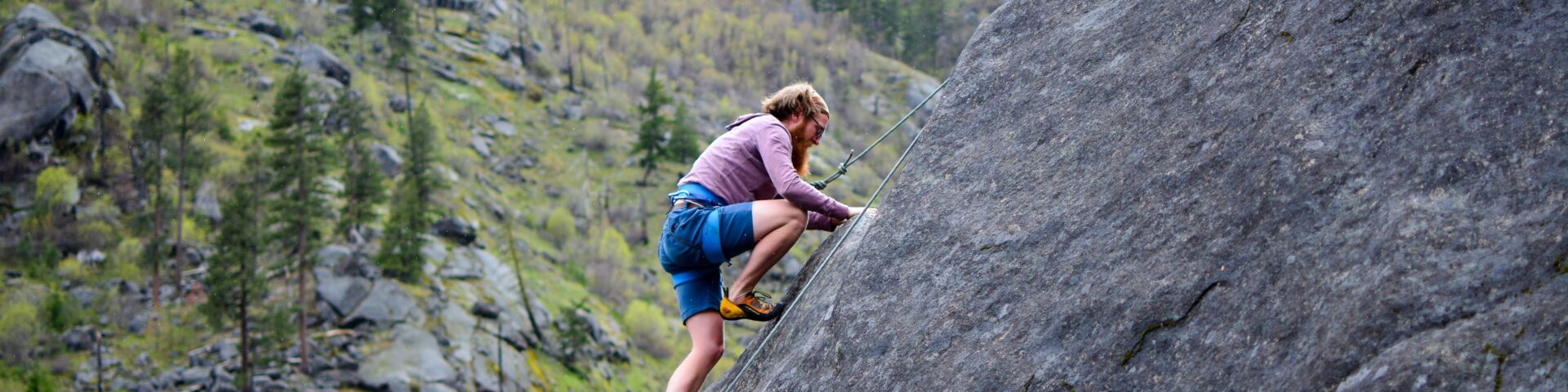 man klimt tegen een rots op als afbeelding bij een blog over beleggingsrisico eerder met pensioen