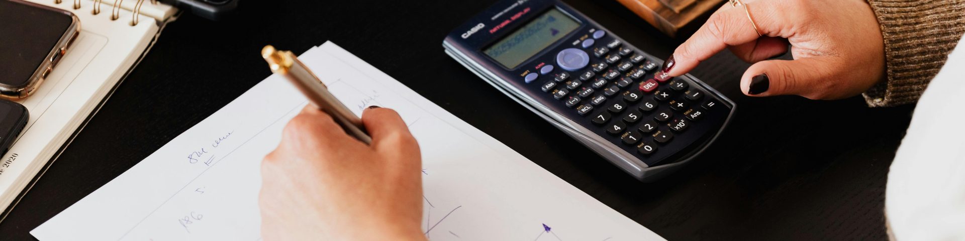 Vrouw maakt een berekening op papier als illustratie bij een blog over eerder met pensioen gaan en je pensioen niet meteen laten ingaan